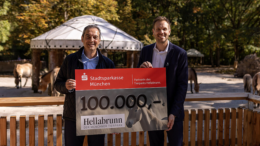 Dr. h.c. Rasem Baban (Hellabrunn) und Jan Mersmann (Stadtsparkasse München) bei der Scheckübergabe vor der neuen Anlage der Przewalski-Urwildpferde im Münchner Tierpark Hellabrunn